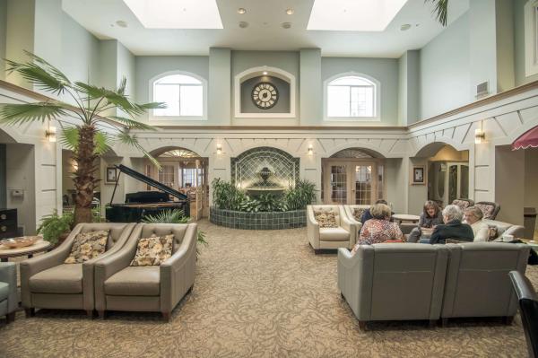 Seniors sit and talk in the formal atrium at Barton Creek