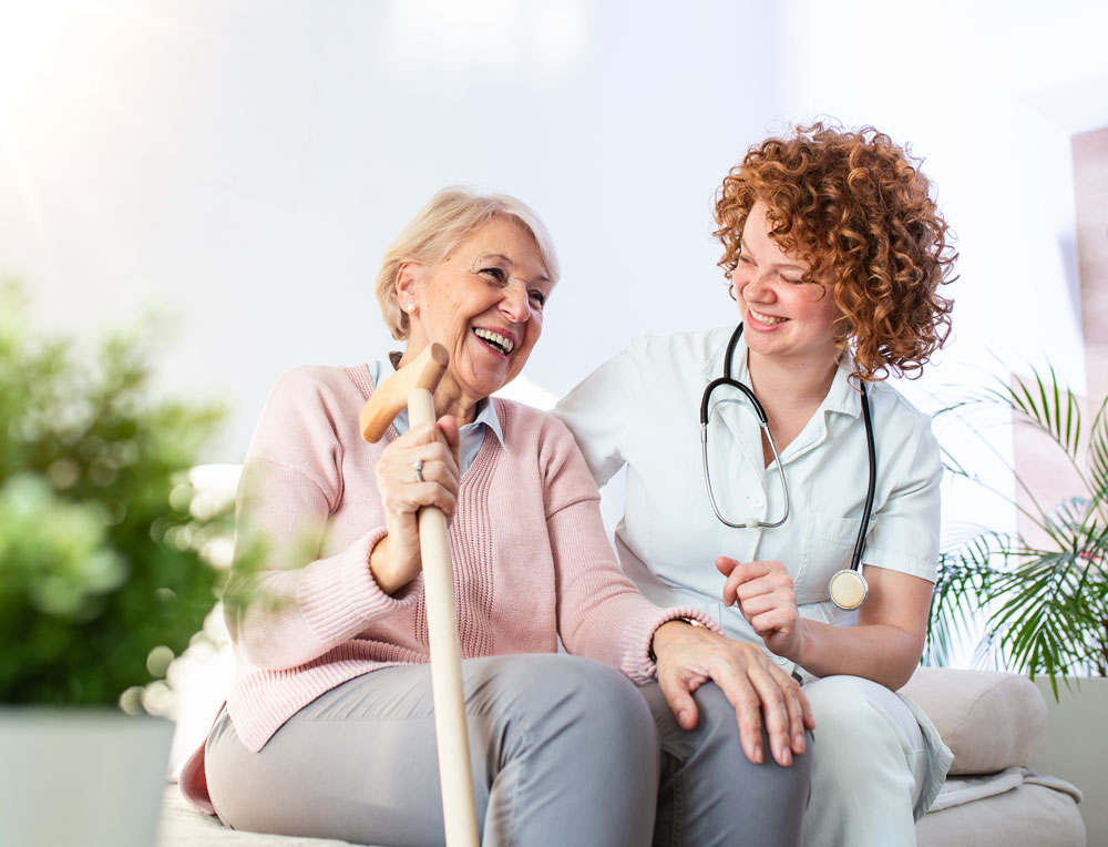 Senior woman and nurse smile together